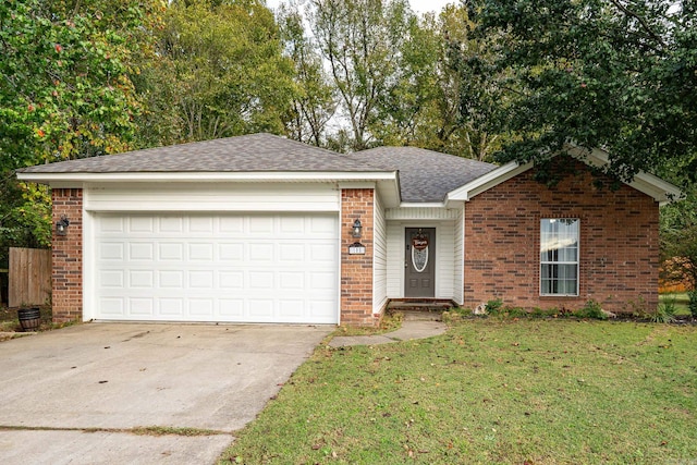 ranch-style house featuring a garage and a front lawn