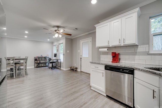 kitchen with white cabinets, decorative backsplash, stainless steel dishwasher, crown molding, and light stone countertops