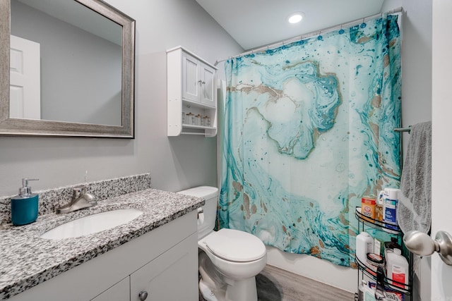 full bathroom with shower / bath combo, wood-type flooring, vanity, and toilet