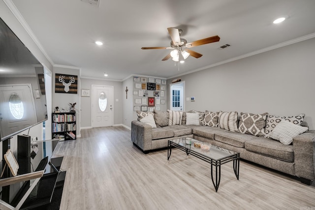 living room featuring ornamental molding, ceiling fan, and light wood-type flooring