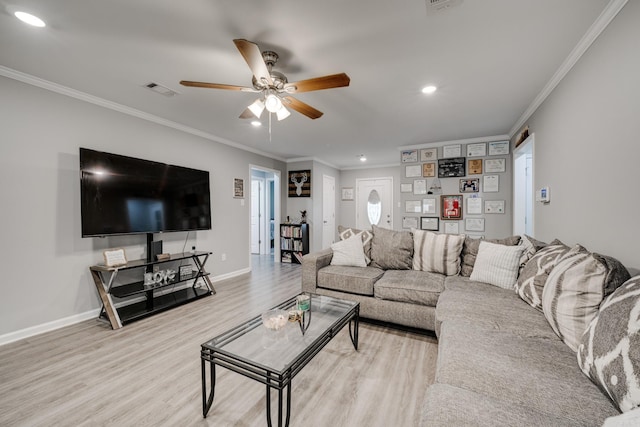 living room with wood-type flooring, ornamental molding, and ceiling fan