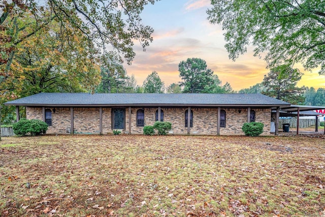 ranch-style house featuring a carport