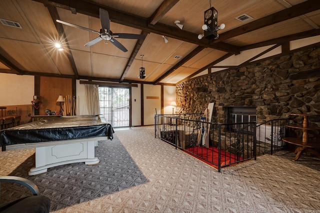 playroom featuring a stone fireplace, wood ceiling, carpet flooring, and vaulted ceiling with beams