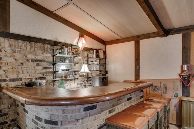 bar with brick wall, beam ceiling, and wooden ceiling