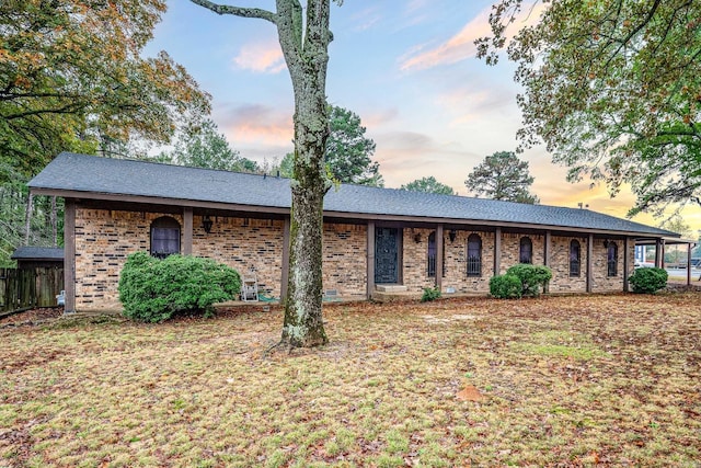 ranch-style home with a lawn