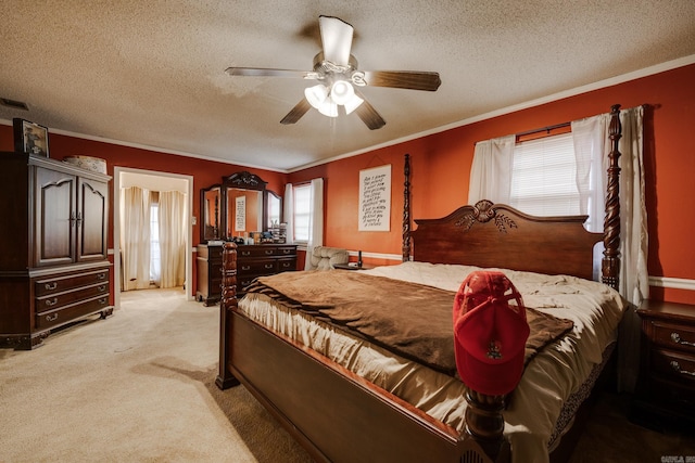 bedroom featuring a textured ceiling, light colored carpet, ceiling fan, and crown molding