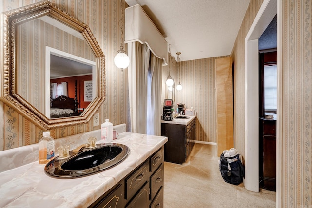 bathroom with vanity and a textured ceiling