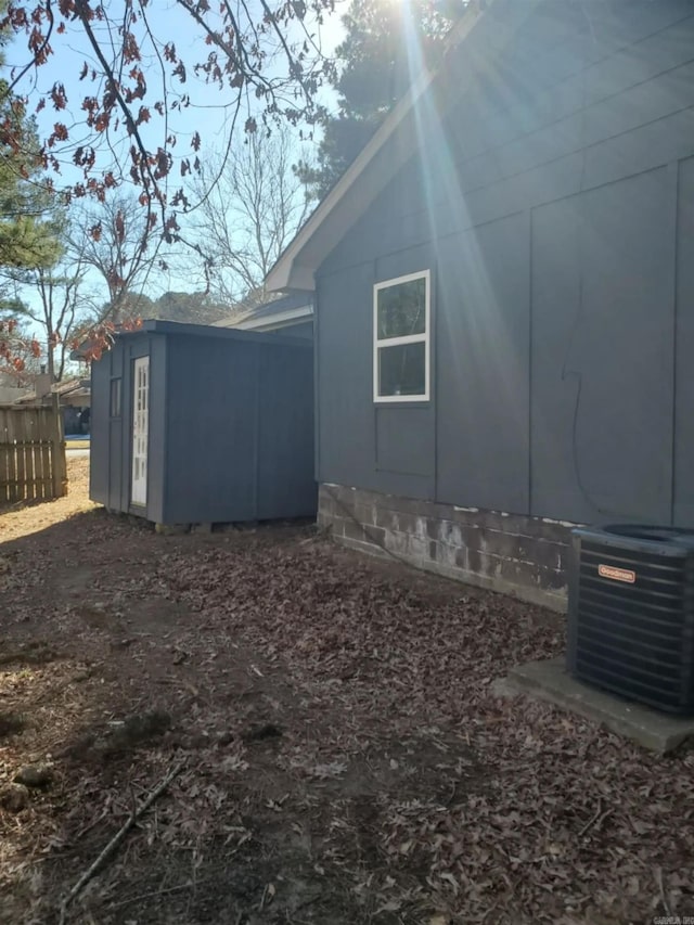 view of side of property with central air condition unit