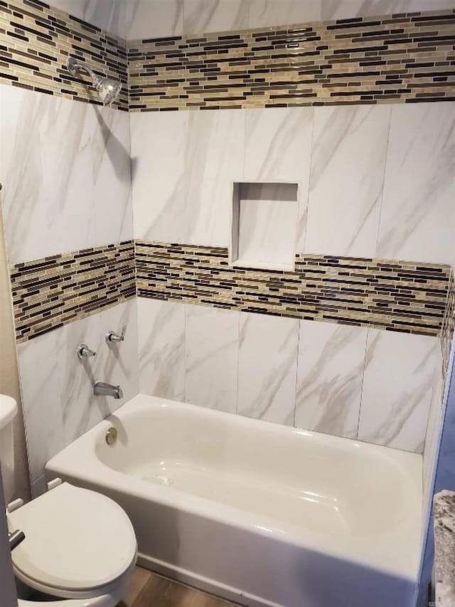 bathroom with toilet and tile walls