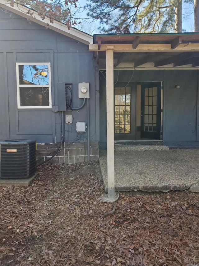 view of side of home with central air condition unit