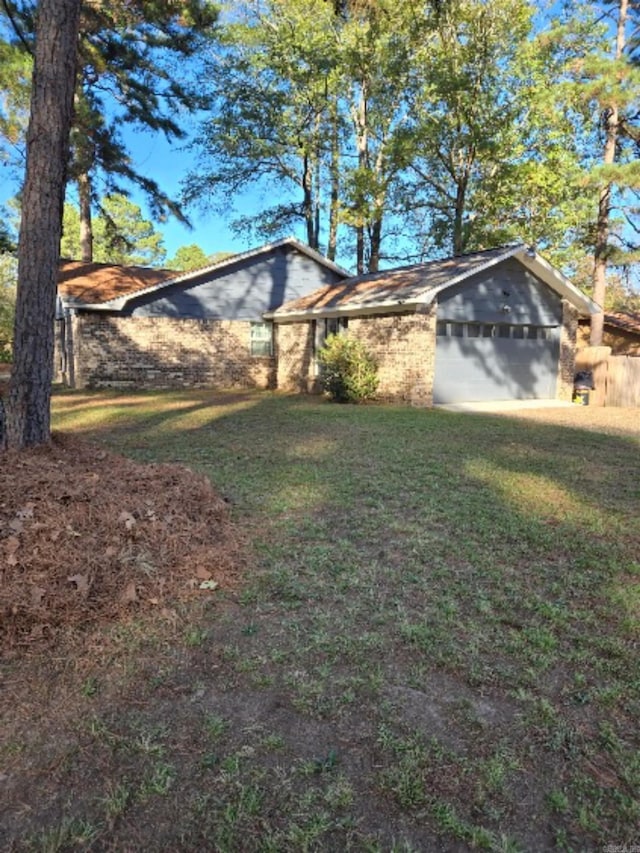 view of property exterior featuring a lawn and a garage