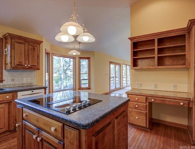 kitchen featuring pendant lighting, wood-type flooring, black electric stovetop, and a center island