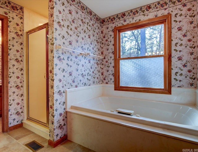 bathroom with tile patterned floors and separate shower and tub