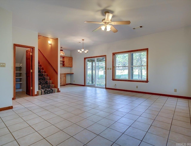 unfurnished living room with light tile patterned flooring and ceiling fan with notable chandelier