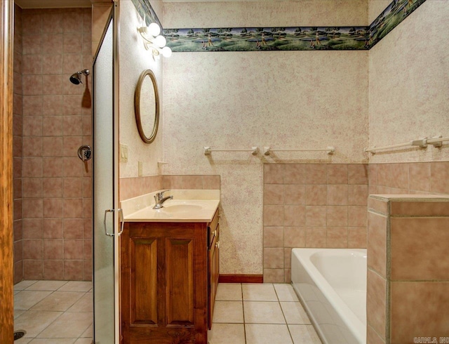 bathroom with tile patterned flooring, shower with separate bathtub, and vanity