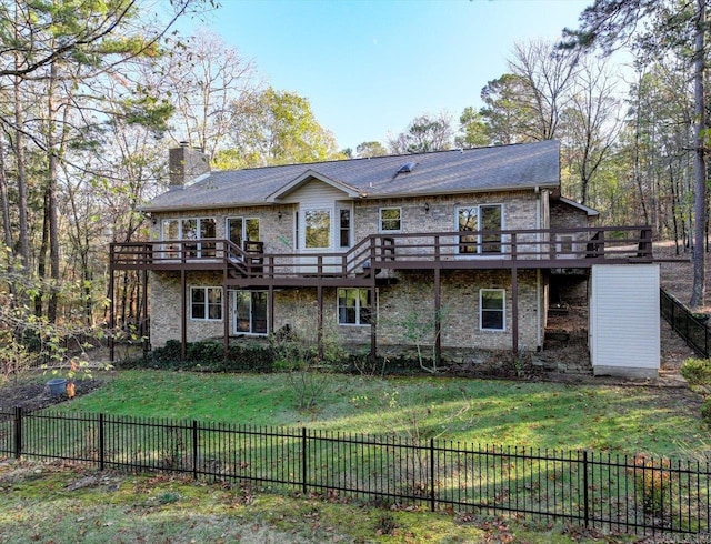 back of property with a lawn and a deck