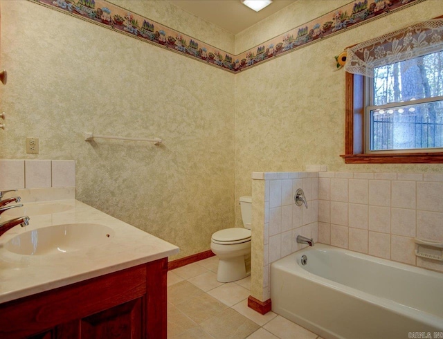 bathroom with toilet, tile patterned flooring, vanity, and a tub