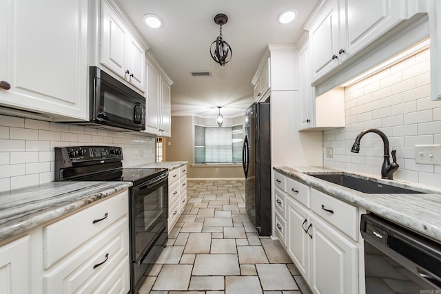 kitchen featuring black appliances, sink, tasteful backsplash, hanging light fixtures, and white cabinetry