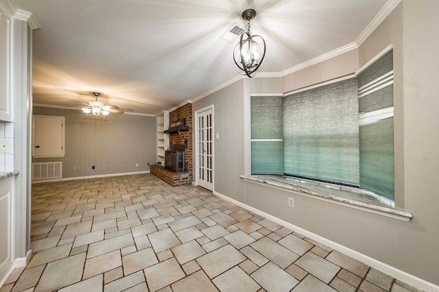 empty room with a brick fireplace, ceiling fan with notable chandelier, and crown molding