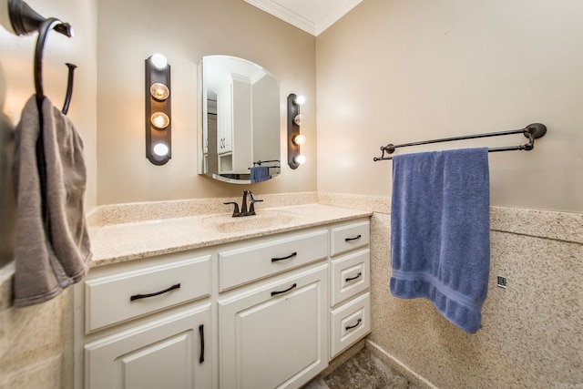 bathroom with ornamental molding and vanity