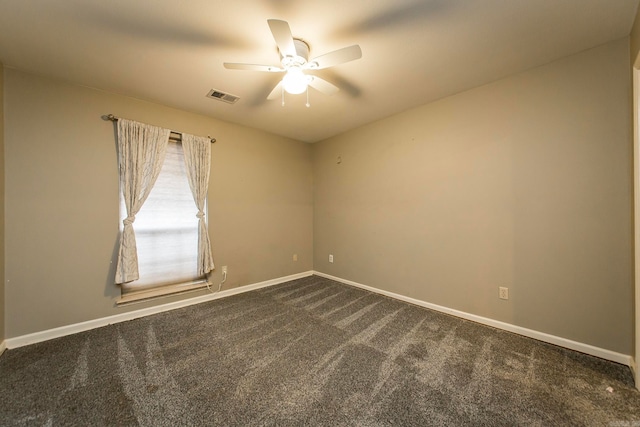 empty room featuring ceiling fan and dark carpet