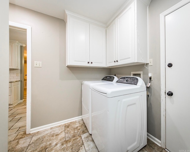 laundry room with cabinets and washing machine and clothes dryer