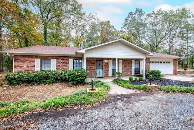 ranch-style home with a garage and covered porch