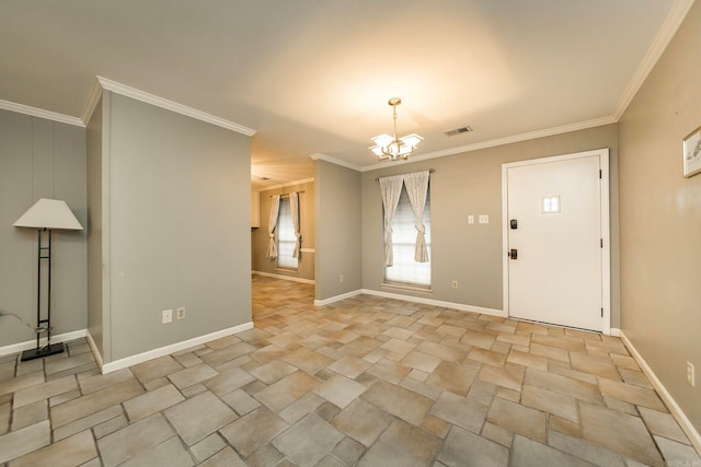 foyer featuring a chandelier and crown molding