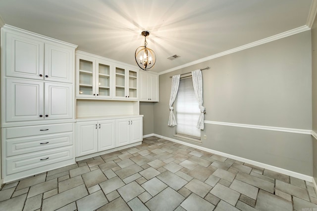 unfurnished dining area with a notable chandelier and crown molding