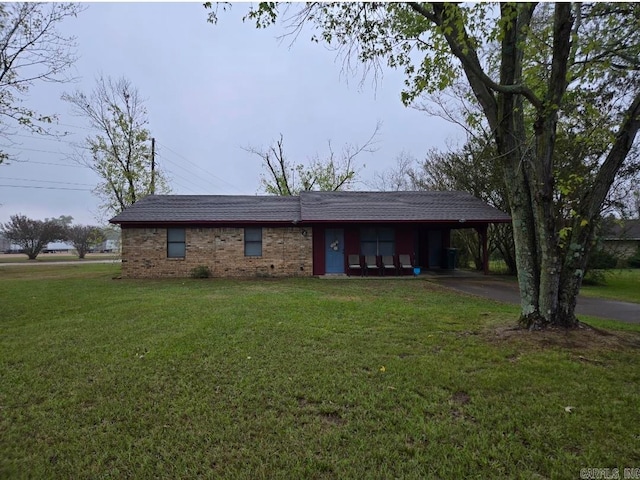 single story home with a front yard and a carport