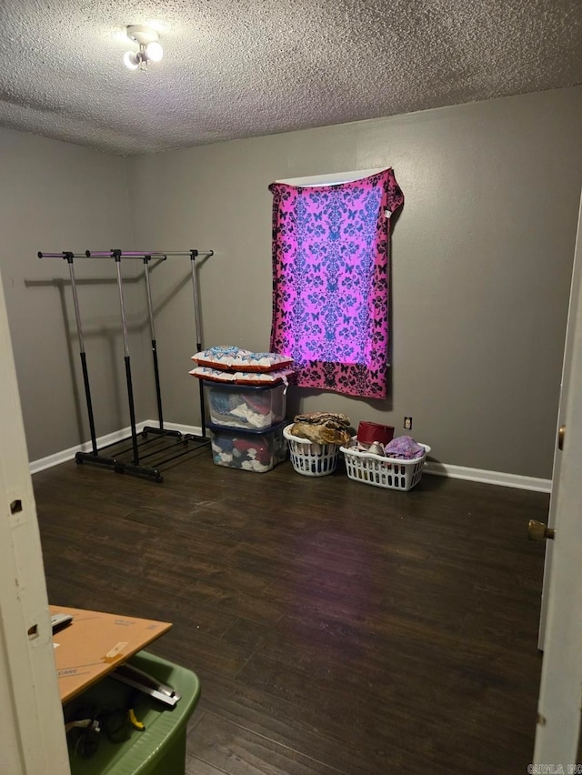 miscellaneous room with a textured ceiling and hardwood / wood-style flooring