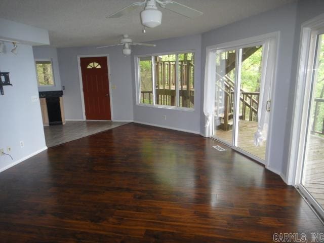 85 Bluff View Dr, Quitman, AR 72131 - unfurnished living room with a ceiling fan, wood finished floors, and baseboards