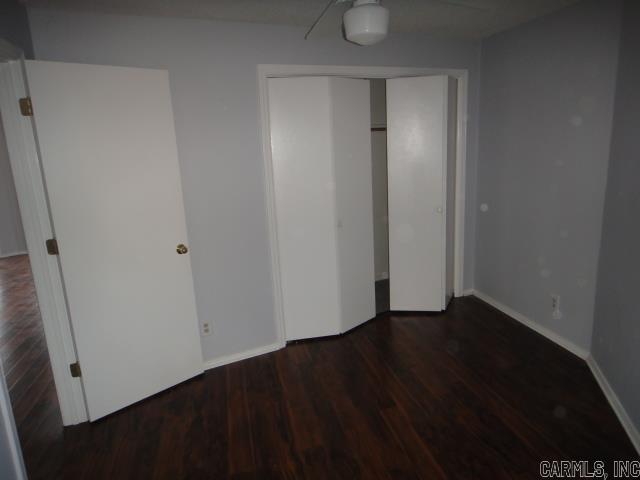 85 Bluff View Dr, Quitman, AR 72131 - unfurnished bedroom with wood finished floors, a closet, and baseboards