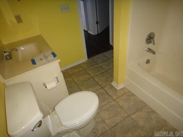 85 Bluff View Dr, Quitman, AR 72131 - full bathroom featuring tile patterned flooring, baseboards, toilet, a sink, and  shower combination