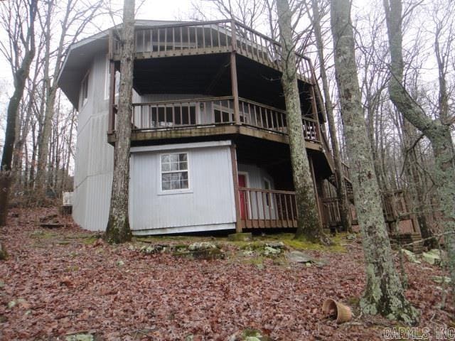 back of property with a wooden deck