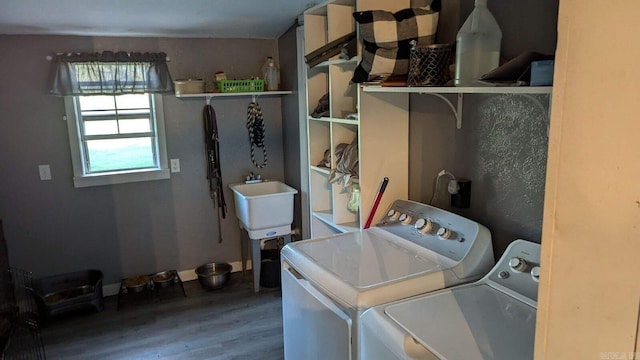 laundry room with hardwood / wood-style floors, sink, and independent washer and dryer