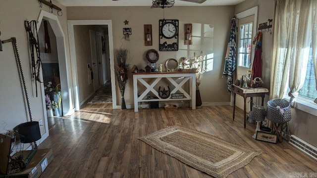 interior space with ceiling fan and wood-type flooring