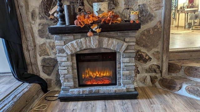 room details featuring a fireplace and hardwood / wood-style floors