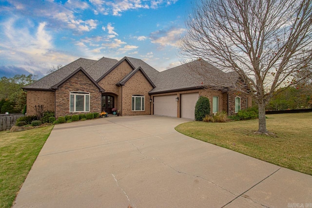 view of front of home with a garage and a front lawn