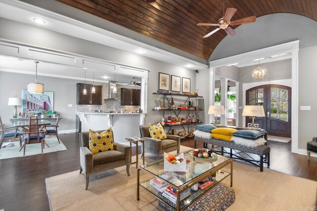 living room with light hardwood / wood-style flooring, vaulted ceiling, decorative columns, wooden ceiling, and ceiling fan with notable chandelier