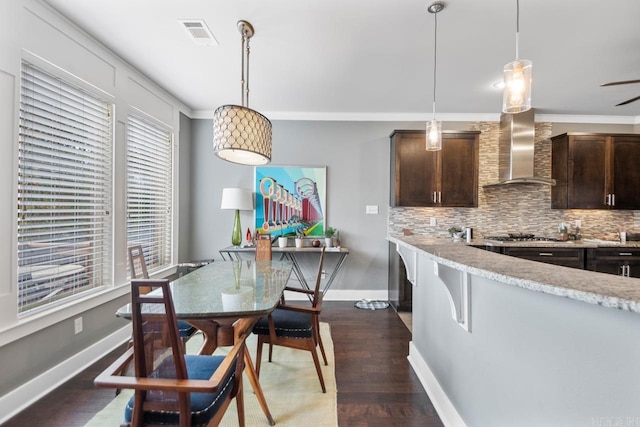 kitchen with pendant lighting, dark hardwood / wood-style flooring, and dark brown cabinets