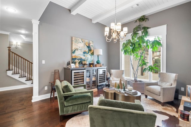 sitting room featuring wine cooler, decorative columns, wood ceiling, a notable chandelier, and dark wood-type flooring