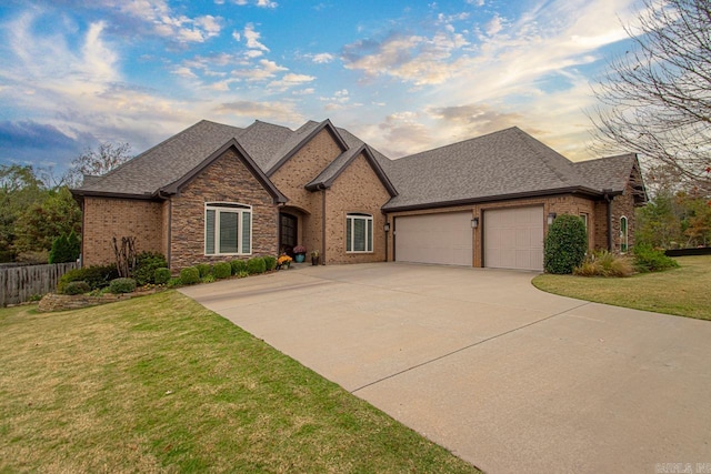 view of front facade with a lawn and a garage