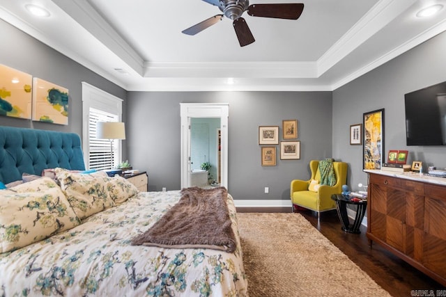 bedroom with ceiling fan, dark hardwood / wood-style floors, a raised ceiling, and ornamental molding