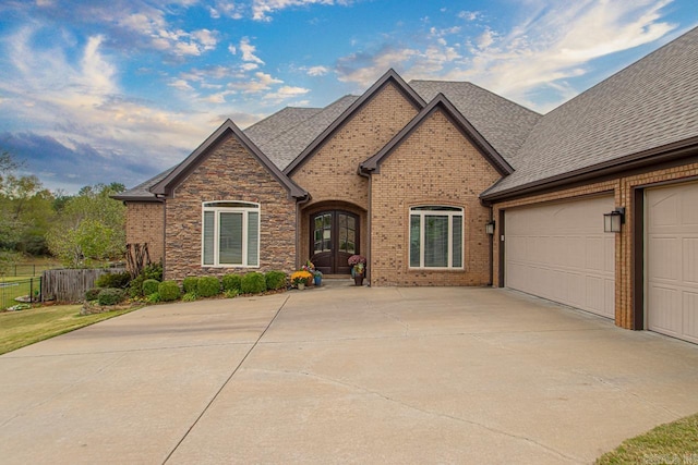 french country home featuring a garage