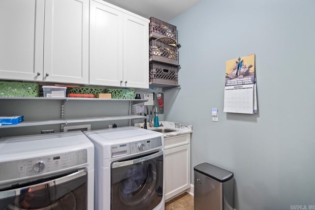 laundry area featuring sink, cabinets, and washing machine and clothes dryer