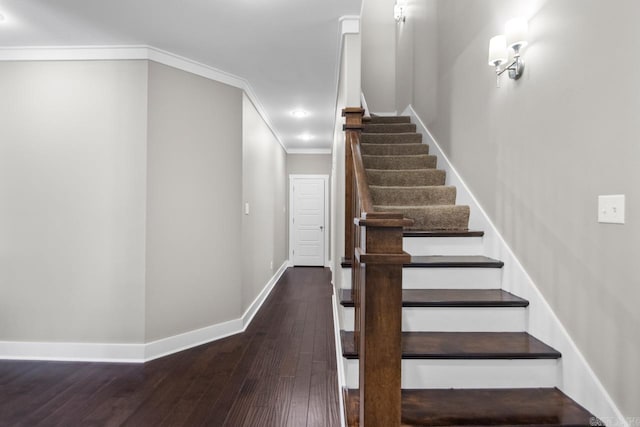 staircase with hardwood / wood-style floors and crown molding