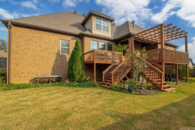 rear view of property featuring a deck and a lawn