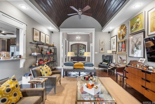 living area featuring hardwood / wood-style floors, wood ceiling, lofted ceiling, and crown molding