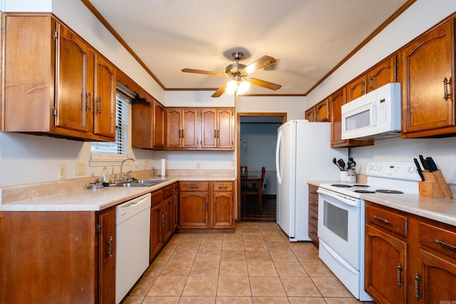 kitchen featuring white appliances, a textured ceiling, sink, and crown molding